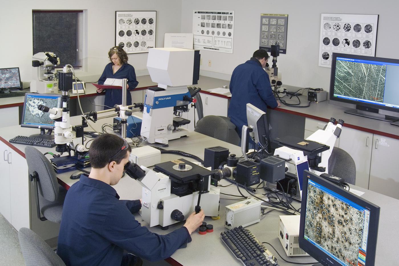 IMR Test Labs metallurgy lab with technicians performing testing, and data recording at analytical equipment