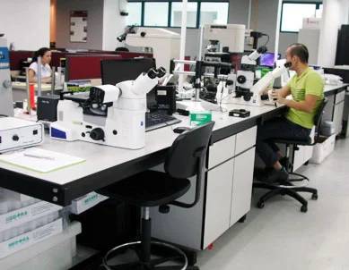 GEAC's Central Coatings Lab in IMR Test Labs Singapore facility with technicians checking analytical data on computers