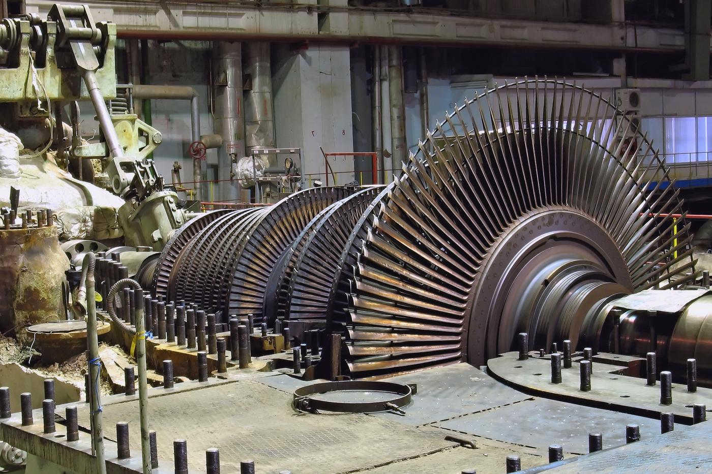 Steam turbine facility with multiple energy-producing turbines from very large size to smaller sized assemblies.