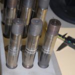 A rack of metal bar samples ready for pull-bond testing