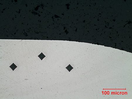 Showing 3 diamond images after Vickers test on a metal sample